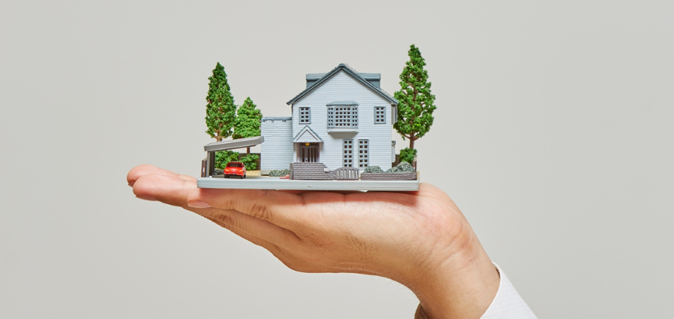 Hand holding a small model home