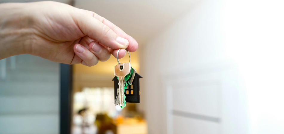 A hand holding house keys