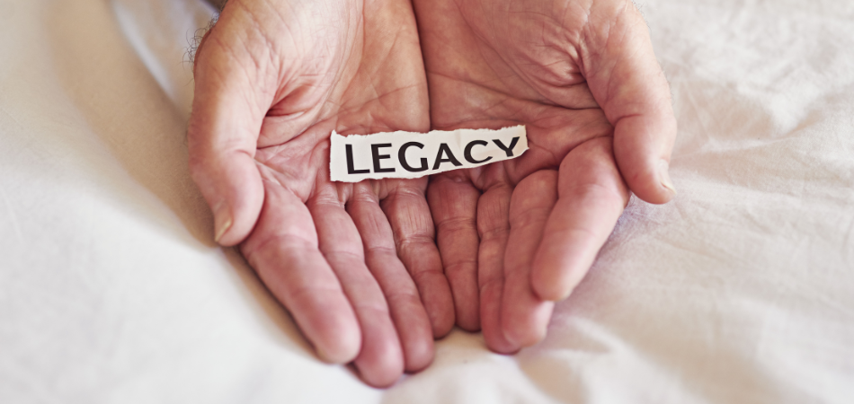 Hands holding a strip of paper that says LEGACY