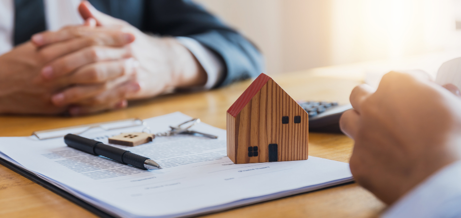 A person siting in a desk talking to another person about a inherit house